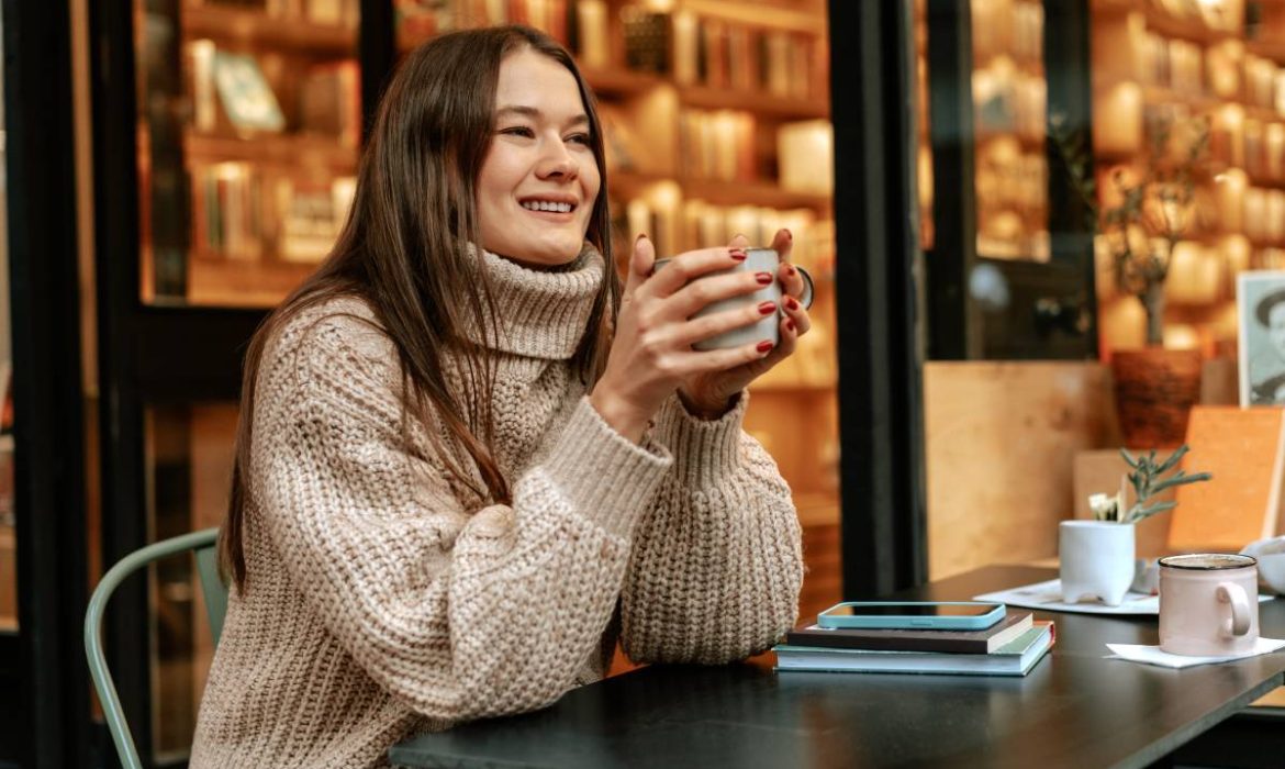 woman drinking coffee during fall after having successful digital marketing