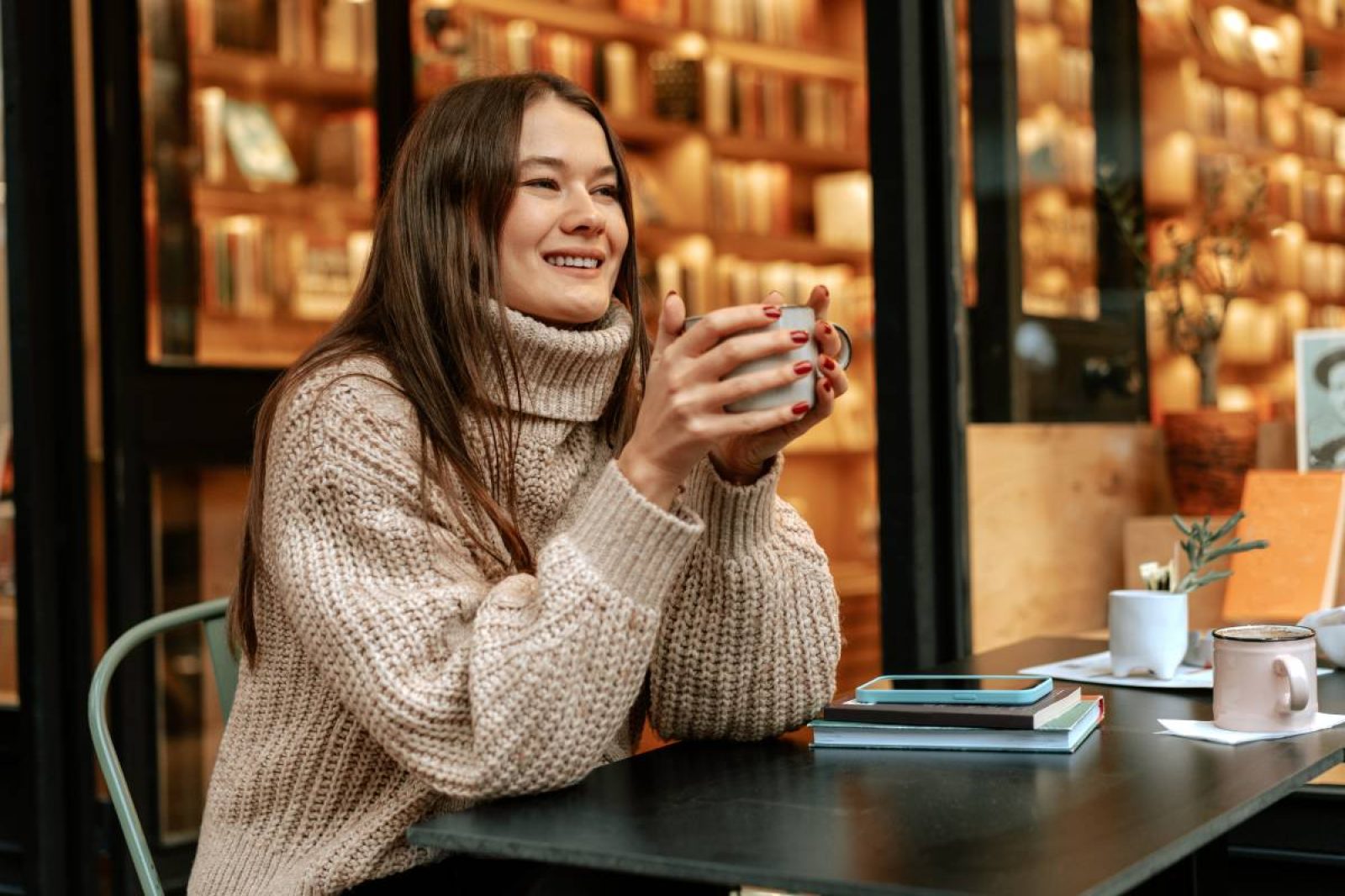 woman drinking coffee during fall after having successful digital marketing