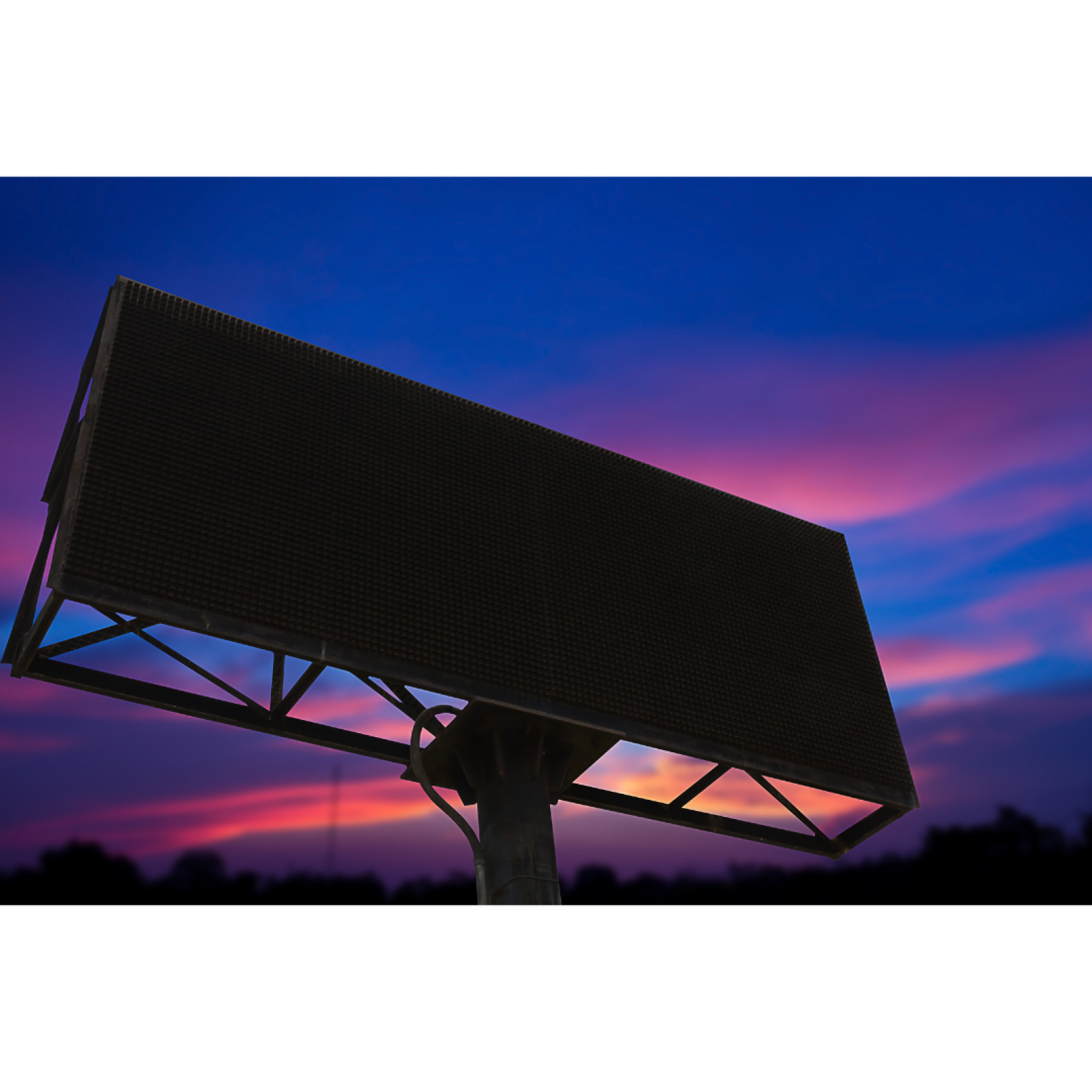 Digital billboard shown during a sunset.