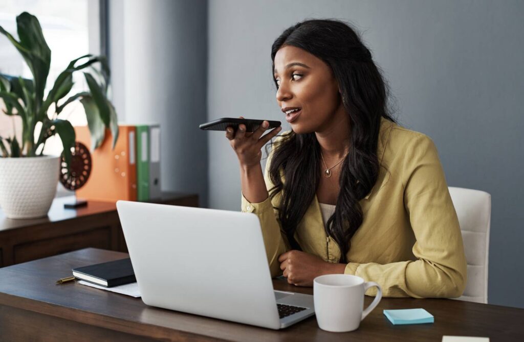 black woman using voice to search for information online.