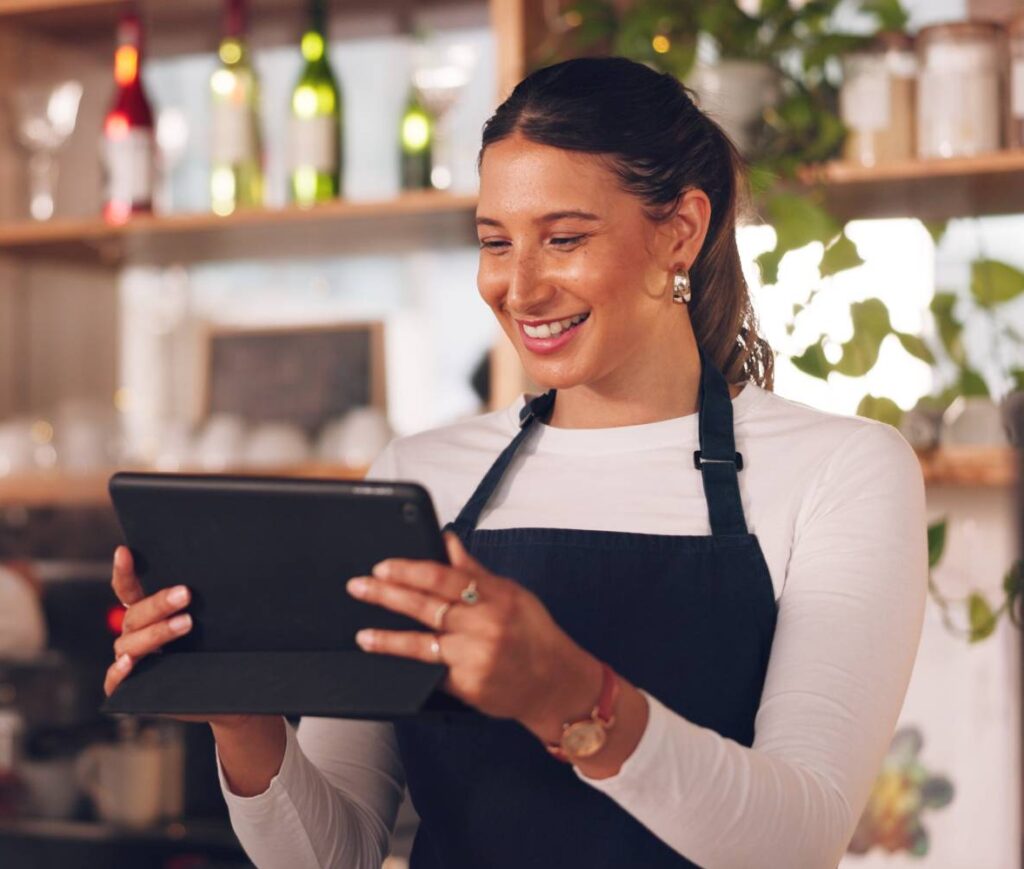 Restaurant owners smiling at table reservations from marketing